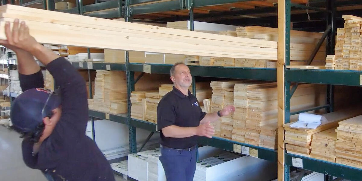 team member and customer looking at lumber