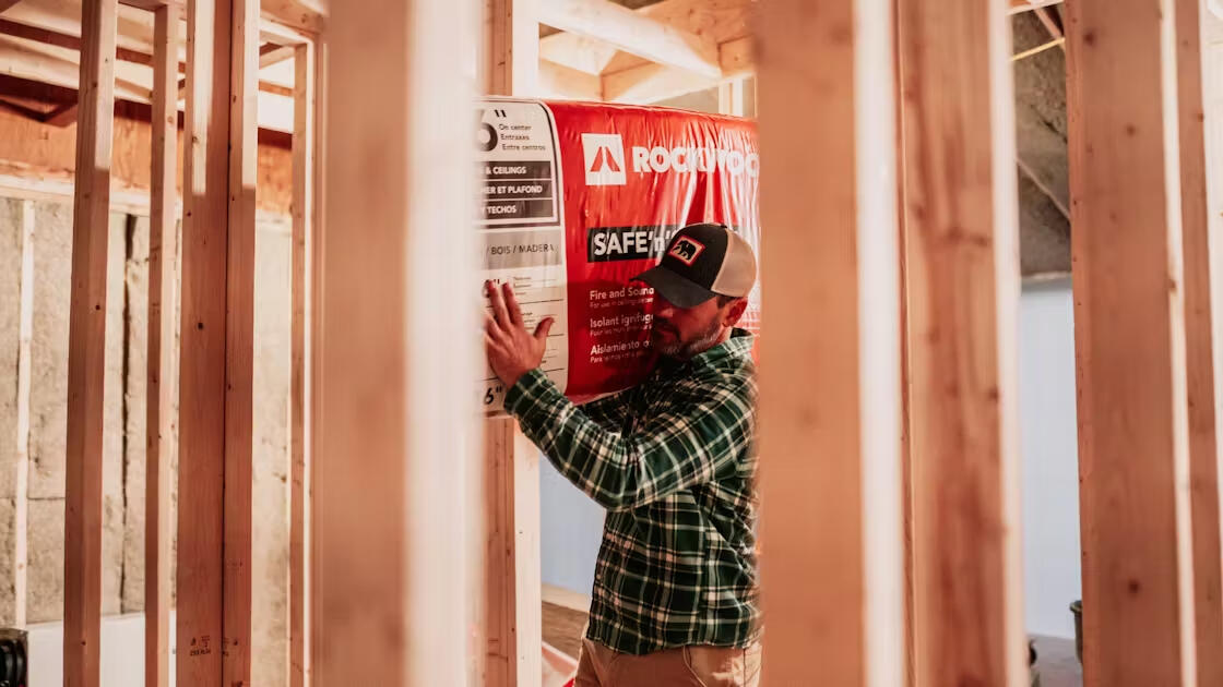 Contractor carrying Rockwool