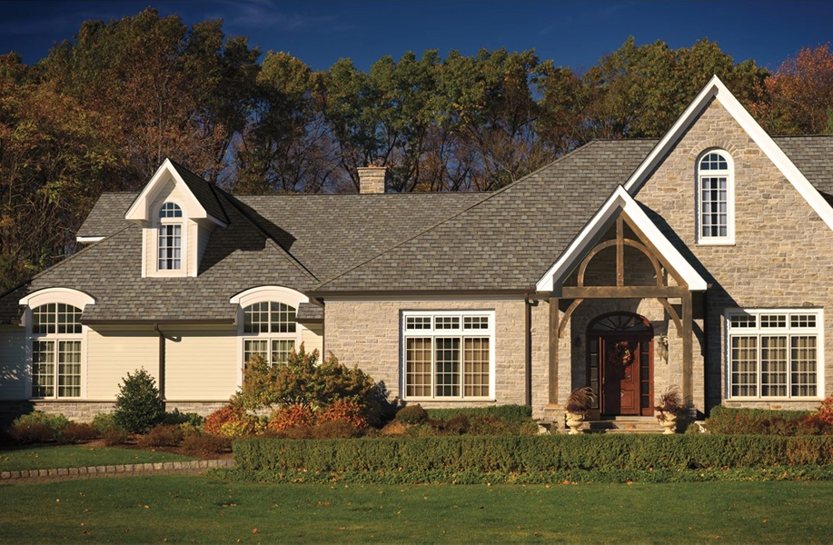 New England home featuring new roofing and siding materials