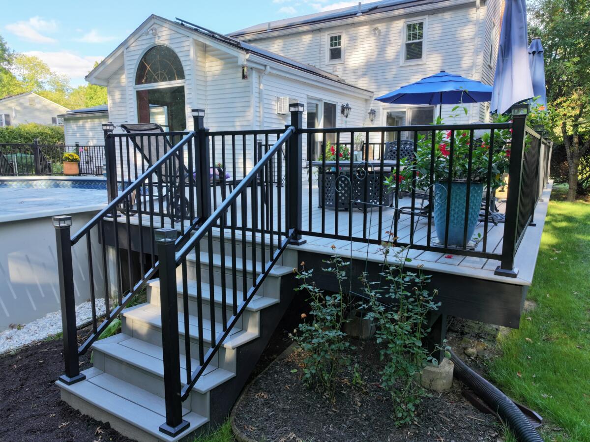 Cavallon Construction built a custom wrap around pool deck in Suffield, CT